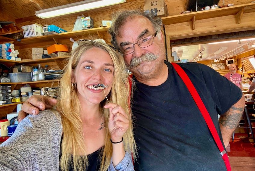Emma MacKinnon smiles with Peter Llewellyn, owner of Shoreline Design. - Photo Contributed.