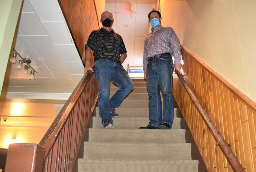 Truro Curling Club board members Cletus MacIsaac and Randy Degrass stand in the stairwell of the club, which currently can't  accommodate all visitors to the facility. A new accessibility lift is in the works with a fundraiser campaign to add to money already donated or secured through grants for the work.