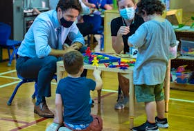 Prime Minister Justin Trudeau visits children at a daycare in St. John's, N.L. in July. The province struck a deal with Ottawa for a $10-a-day child-care program.