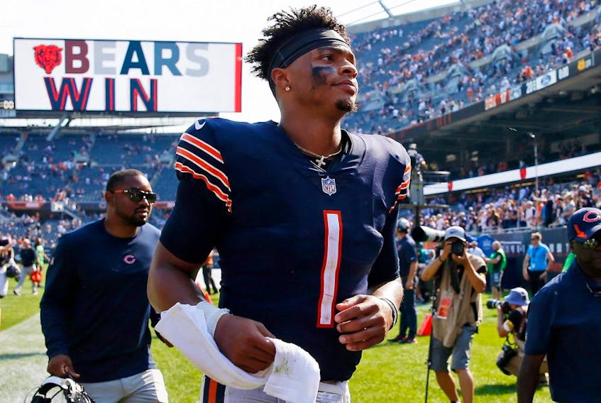 Chicago Bears quarterback Justin Fields runs off the field after his team's 20-17 win over the Cincinnati Bengals at Soldier Field on Sept. 19, 2021.