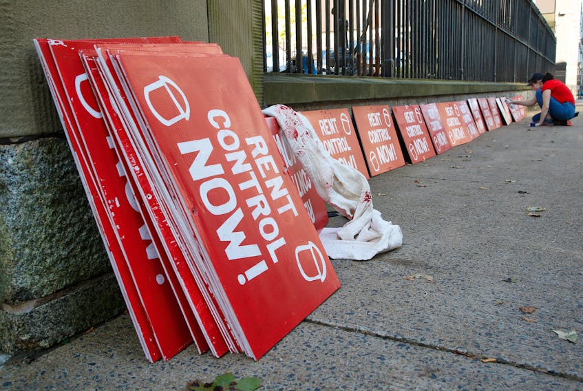 FOR CAMPBELL STORY:
A demonstrator taking part in a rent cap rally put on by the advocacy group, ACORN, prepares signs for their day-long rally to maintain the cap on rental increases, in front of Province House in Halifax Thursday September 23, 2021.

TIM KROCHAK PHOTO