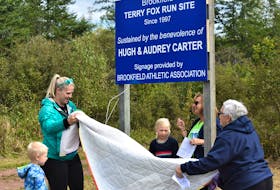 Taking part in the unveiling of the sign honouring the late Hugh and Audrey Carter were the couple’s granddaughter-in-law Christina Lutes (left) with her children and their great-grandchildren Eli and Audrey, as well as Terry Fox Run committee members Kim Dawe and Judy Matheson.