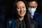  Meng Wanzhou, chief financial officer of Huawei, smiles as she leaves her home in Vancouver on Friday, Sept. 24, 2021. THE CANADIAN PRESS/Darryl Dyck