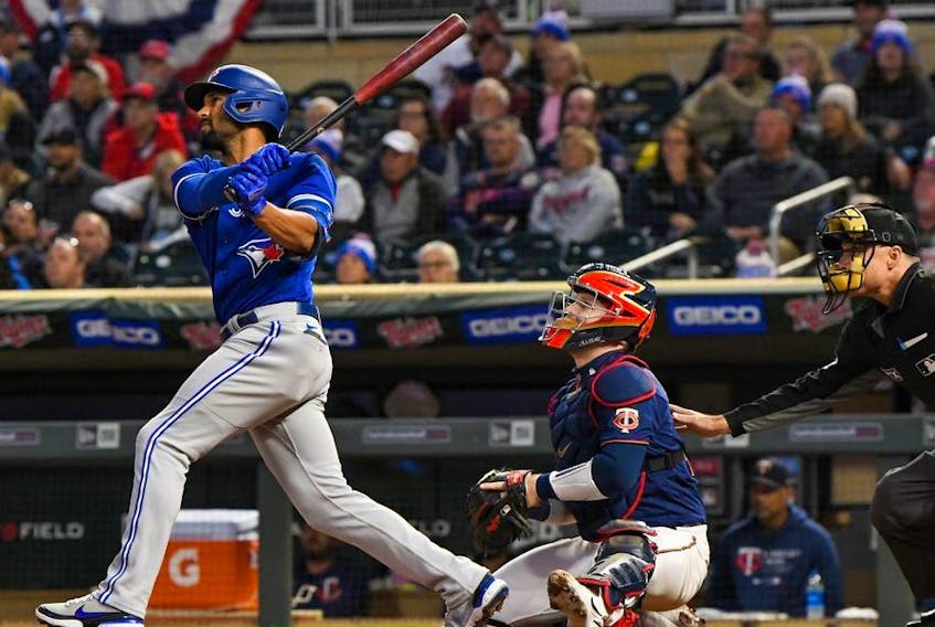 Toronto Blue Jays infielder Marcus Semien (10) hits a double off of Minnesota Twins starting pitcher Bailey Ober (82) during the first inning at Target Field. 