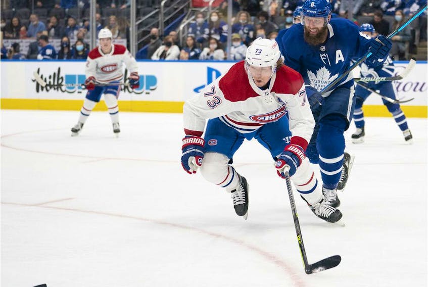 Maple Leafs defenceman Jake Muzzin (8) battles for the puck with Montreal Canadiens' Tyler Toffoli (73) during the first period at Scotiabank Arena in Toronto on Saturday, Sept. 25, 2021. 