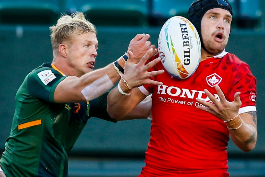 Canada's Jake Thiel, right, battles for the ball against South Africa's J.C. Pretorius during HSBC Canada Sevens rugby action in Edmonton on Saturday, Sept. 25, 2021.