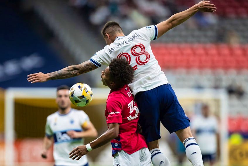  CP-Web. FC Dallas’ Justin Che (32) and Vancouver Whitecaps’ Jake Nerwinski (28) vie for the ball during the first half of an MLS soccer game in Vancouver, on Saturday, September 25, 2021.