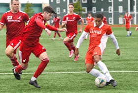 It's a little difficult distinguishing the red jerseys of the Memorial Sea-Hawks and orange of the Cape Breton Capers, but that's Memorial captain Harry Carter moving in to challenge Cape Breton forward and St. John's native Owen Sheppard (20) during what turned out to be a scoreless tie in AUS men's soccer in Sydney. N.S., on Saturday. Looking on are Zach Visser (23) and Jacob Grant (9) of the Sea-Hawks. — CBU Athletics