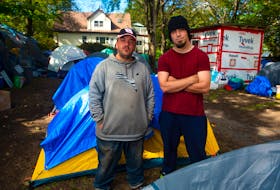 John Walter Griffin (left) and Nate Thorburne pose for a photo in the People's Park in west end Halifax on Monday, Sept. 27, 2021. Griffin and Thorburne have both been living in the park for the last few weeks.
