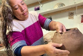 Eskasoni potter Nancy Oakley working on a traditional Mi'kmaq cooking pot.