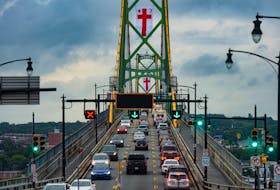 Vehicles pass over the Macdonald Bridge as Mi'kmaq Grand Council flags fly from the bridge towers in recognition of Thursday's National Day for Truth and Reconciliation on Tuesday, Sept. 28, 2021.