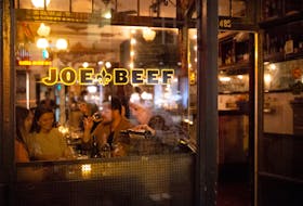 Patrons dine at Joe Beef in Montreal in 2020. Fittingly for trying times, the acclaimed restaurant sells a cookbook titled Surviving the Apocalypse. REUTERS/Christinne Muschi/File Photo
