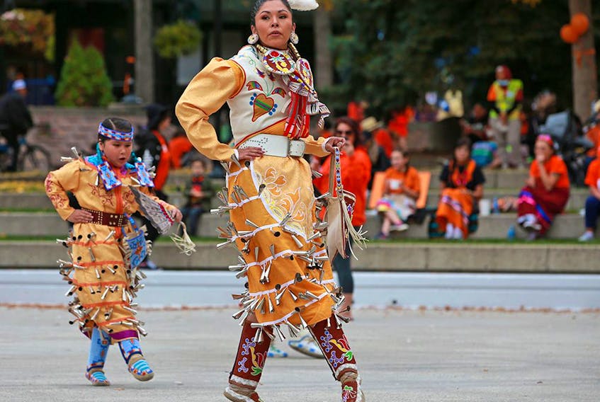  Young jingle dancers and their mothers danced at the Orange Shirt Day event at Olympic Plaza on Saturday, September 25, 2021. Orange Shirt Day encourages everyone to commemorate the residential school experience, to witness and honour the healing journey of the survivors and their families, and to commit to the ongoing process of reconciliation.