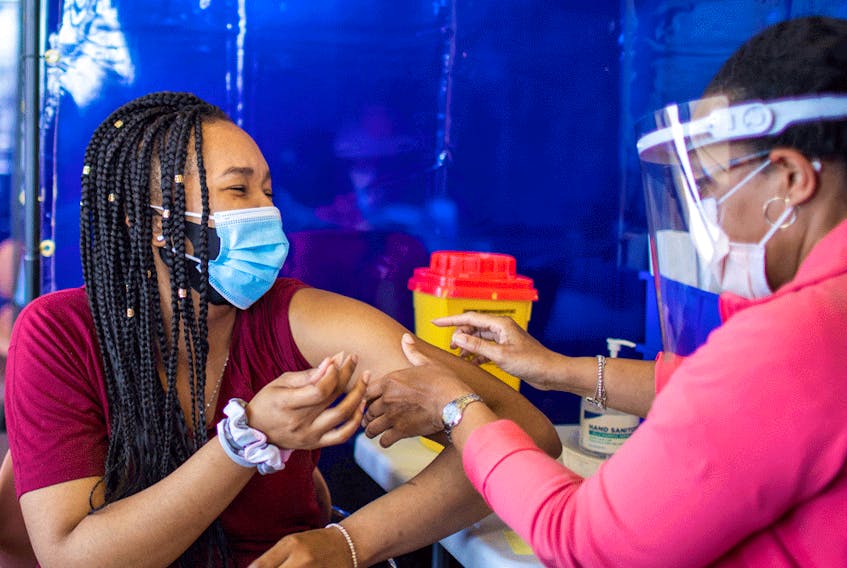 A healthcare worker administers a Pfizer COVID-19 vaccine at a pop up clinic in Brampton, Ontario.