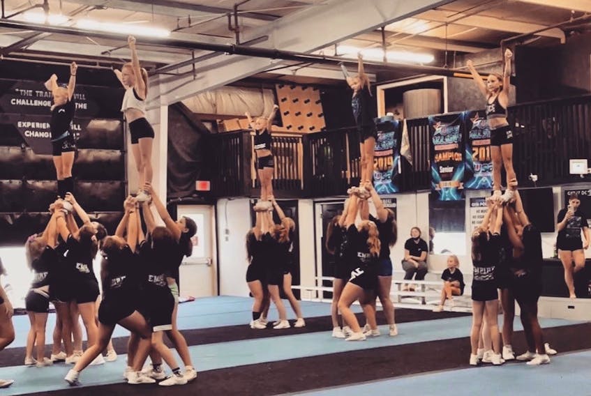 ICE’s athletes work on overhead stunt drills before adding their flyers into the mix.