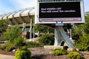  An advertisement promoting COVID-19 vaccinations is visible on a digital billboard outside Commonwealth Stadium in Edmonton on Monday, Aug. 30, 2021.