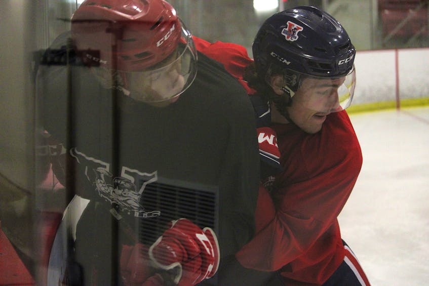 Defenceman Keigan Casey, right, pins forward Josh Crooks to the boards during an intrasquad game on Sept. 2 on Day 2 of the Valley Wildcats training camp. Casey, a 20-year-old Hammonds Plains native, has played the past two seasons with Valley. Crooks, a 19-year-old Cole Harbour native, played the past two seasons with the Campbellton Tigers, who traded him to Truro in August. Valley acquired him in a deal for Sonny Kabatay. - Jason Malloy