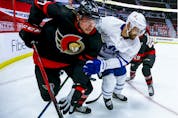 Ottawa Senators centre Logan Brown and Toronto Maple Leafs left wing Nick Foligno fight for position.