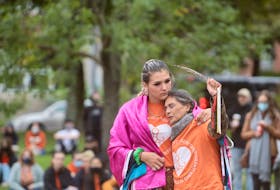 Kyra Gilbert, holds her mother Darleen Thunderbird Swooping Down Woman during a ceremony at Peace and Friendship Park commemorating the first Truth and Reconciliation Day in Canada. Darleen says her mother was a child on the residential school system.