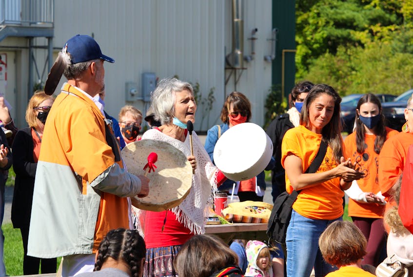 Carolyn Landry, centre, plays a drum and sings during the National Day for Truth and Reconciliation ceremony in Kentville on Sept. 30.
