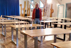 Neal Livingston stands in the midst of his collection of recently created dining room tables at his storage facility in western Cape Breton. The Inverness County woodlot owner, filmmaker, renewable-energy advocate, artist and environmentalist began making artistic dining room and coffee tables from lumber harvested on his small woodlot. CONTRIBUTED