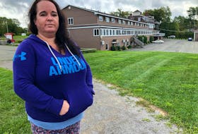 Reena MacIntosh stands in the municipal park beside the Harbourview Inn and Suites, where she has been living since September when she moved back to Cape Breton. On Tuesday, she paid for another month to stay at Harbourview but when the new owner took over the property the next day, MacIntosh and dozens of other monthly renters were told they were "guests" not tenants and had to leave within days. NICOLE SULLIVAN/CAPE BRETON POST 