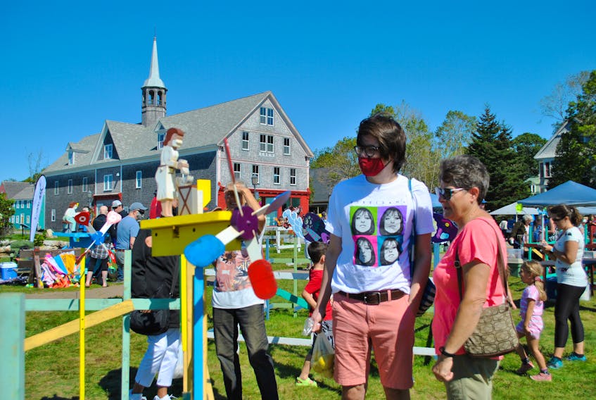 People stroll through the display at the 21st annual Whirligig and Weathervane Festival on Sept. 18 and 19 on the Shelburne waterfront. KATHY JOHNSON