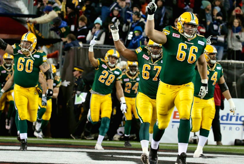 Edmonton Elks offensive lineman Matt O'Donnell (66) leads the charge onto IG Field in the 103rd Grey Cup in Winnipeg on Nov. 29, 2015.