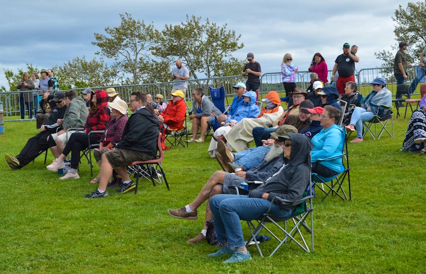 People attending the Acoustic Roots Festival take in a performance on a mild Sunday afternoon at Two Rivers Wildlife Park. — IAN NATHANSON/CAPE BRETON POST  - Ian Nathanson