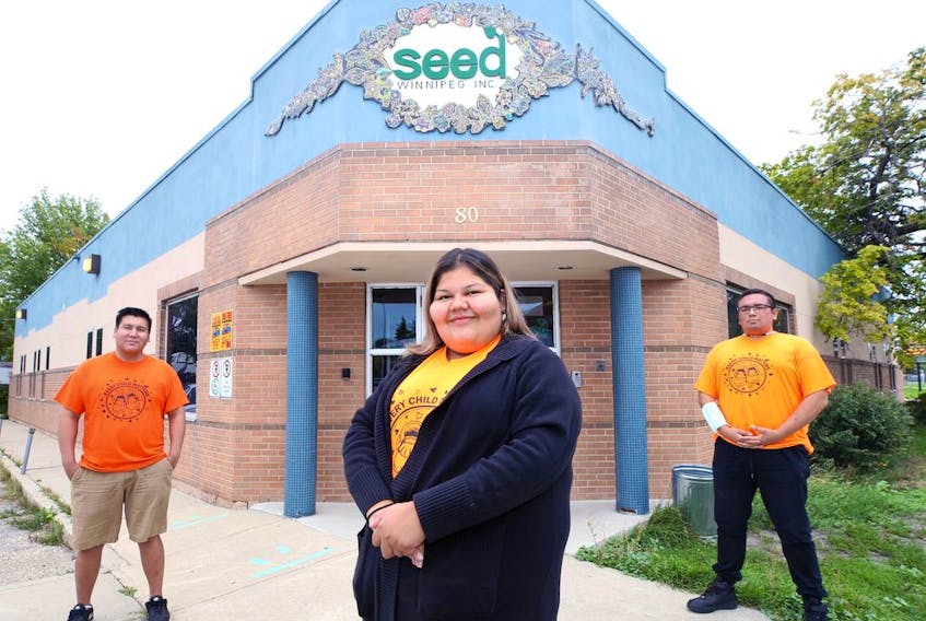  Money Stories facilitators Justin Huntinghawk, Calandra Necan, and Andrew Proulx-Courchesne (from left) pose in front of the SEED Winnipeg office on Salter Street on Thursday, Sept. 2, 2021.