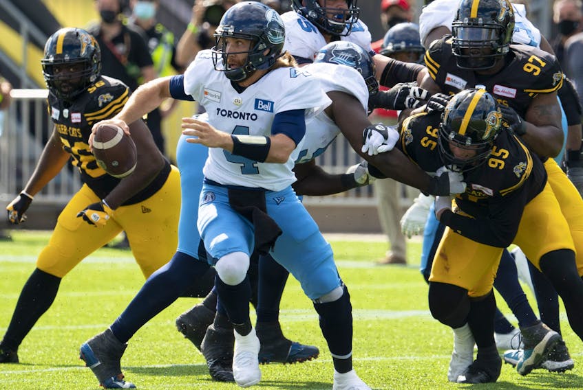 Argonauts quarterback McLeod Bethel-Thompson scrambles under pressure by the  Tiger Cats defence during their Labour Day Classic in Hamilton, Ont., Monday, Sept. 6, 2021. 