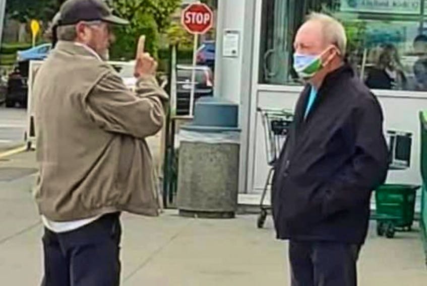 Ivan Scott of Keep the RCMP in Surrey and Surrey Mayor Doug McCallum, right, have a heated conversation in a grocery store parking lot on Saturday in South Surrey.