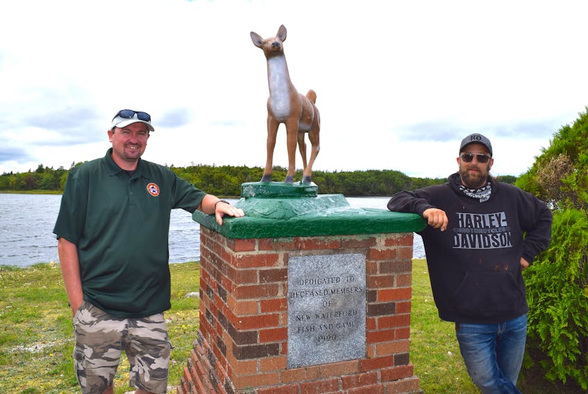 Jeff McNeil, left, of Scotchtown, president of the Port Morien Wildlife Association, stands with Brian ‘Munchie’ MacDonald, owner of New Waterford Recycling, by the new doe statue at the New Waterford Fish and Game Sportsmen’s Memorial Park in River Ryan. McNeil said while their association was revitalizing the park many people mentioned missing the 30-year old  iconic statue which was destroyed by vandalism about 15 years ago and with MacDonald’s help a new one has been erected. Sharon Montgomery-Dupe/Cape Breton Post