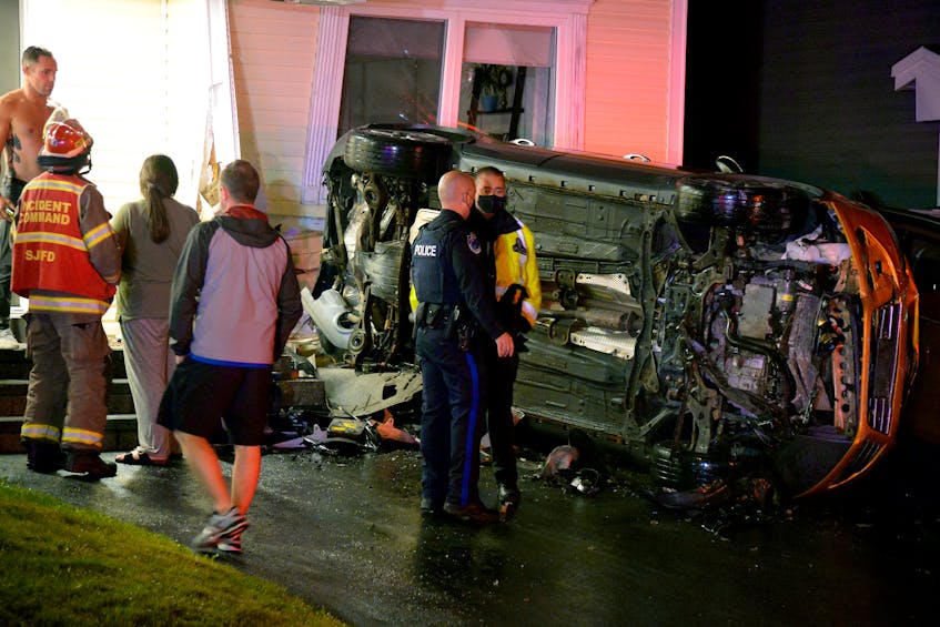 One man was sent to hospital following a crash that sent an overturned parked vehicle into a house Tuesday night. Keith Gosse/The Telegram 
