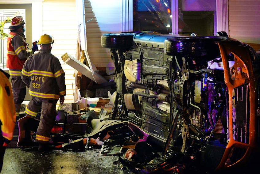 One man was sent to hospital following a crash that sent an overturned parked vehicle into a house Tuesday night. Keith Gosse/The Telegram