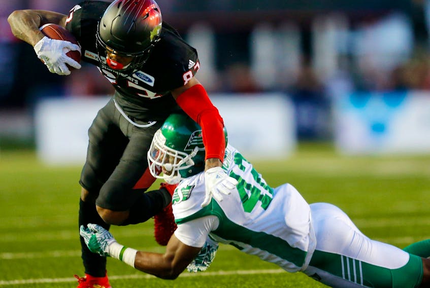 Saskatchewan Roughriders Derrick Moncrief tackles Calgary Stampeders ballcarrier Markeith Ambles at McMahon Stadium in Calgary on Oct. 20, 2018.
