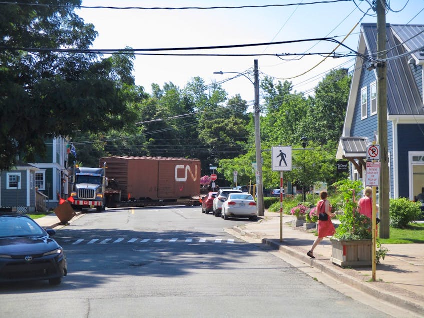 A historic train boxcar arrives in Wolfville via flatbed truck on Aug. 25. CONTRIBUTED