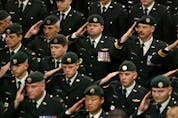 Members of Canada's military pay their respects to Sgt. Robert Short, 42, and Cpl. Robbie Beerenfenger, 29, at a memorial service in Pembroke in the fall of 2003.