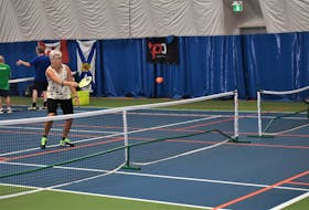 Rhonda Brassard and Deb Tully during a recent pickleball match at the Cougar Dome. The accessible game is steadily growing in popularity.