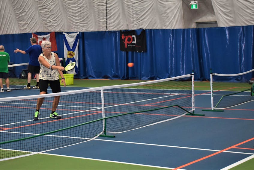 Rhonda Brassard and Deb Tully during a recent pickleball match at the Cougar Dome. The accessible game is steadily growing in popularity.