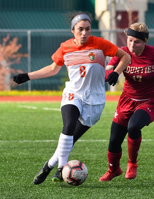 Former Cape Breton Capers' player Ciera Disipio, left, is shown in action during her time as a star midfielder. The perennial all-star, who won the last three AUS women’s soccer most valuable player awards, is now an assistant coach with the team. PHOTO/VAUGHAN MERCHANT, CBU ATHLETICS - David Jala