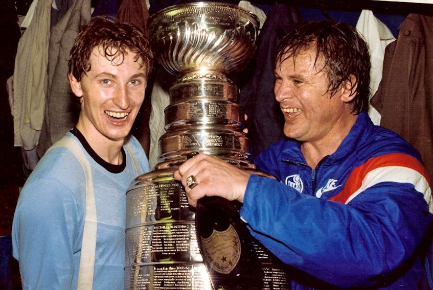  Wayne Gretzky (left) and Garnet ‘Ace’ Bailey in the dressing room after the Edmonton Oilers won their first Stanley Cup Championship in Edmonton on May 19, 1984. SUPPLIED PHOTO