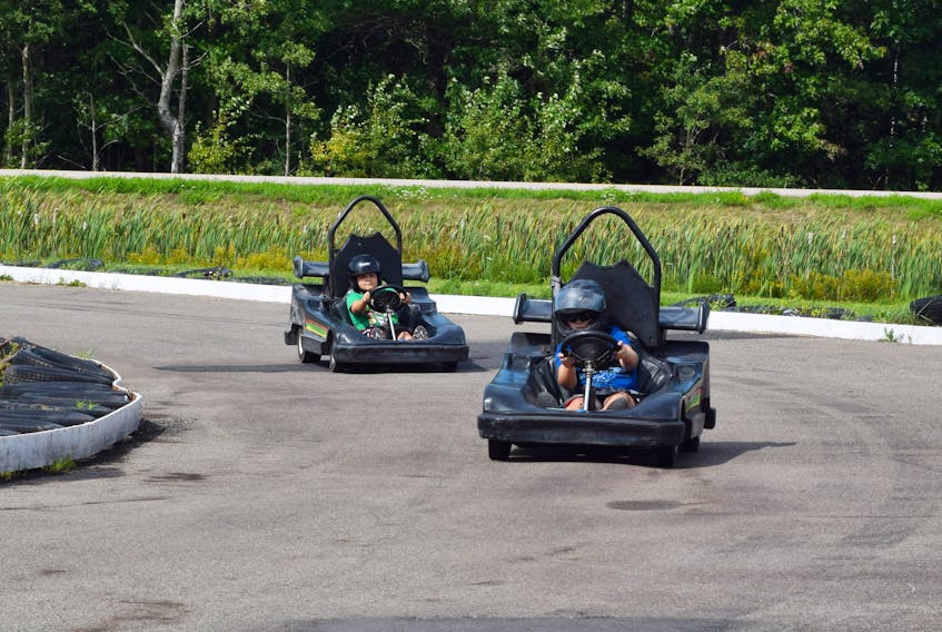 Brothers Brandt and Haiden Stewart race go-karts around the Pleasant Valley Motor Speedway.
