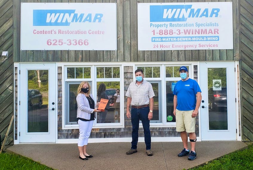 Carla Arsenault, president and CEO of the Cape Breton Partnership presents John Whittington and Craig Marchand of WINMAR Cape Breton with the Safety Culture Champion Award. 