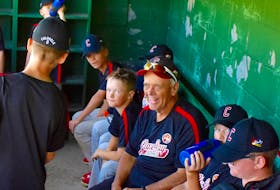 In this 2019 file photo, the late Henry Boutilier, middle, is shown in the dugout with members of the Glace Bay McDonald’s Colonels at the Cameron Bowl in Glace Bay. The longtime coach died late last year after a battle with cancer. DAVID JALA/CAPE BRETON POST