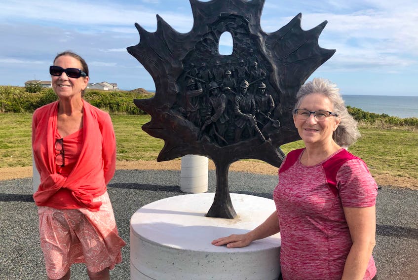 Mary Pat Mombourquette, left, and Joanne Shepard stand next to the bronze memorial monument depicting the 12 miners who died during the 1979 explosion at No. 26 colliery in Glace Bay. NICOLE SULLIVAN/CAPE BRETON POST 