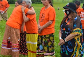 Charlotte Morris, a residential school survivor, receives a hug during a ceremony at the Abegweit First Nation in June to remember the 215 children whose remains were found in Kamloops, B.C. P.E.I. has chosen to recognize the National Day of Truth and Reconciliation to further remember those deaths and the ongoing toll of residential schools.