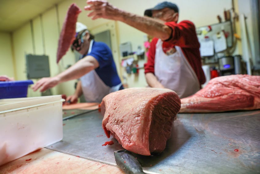 Meat is trimmed to be ground at a butcher shop in New Tripoli, Penn. REUTERS/Jonathan Ernst/File Photo
