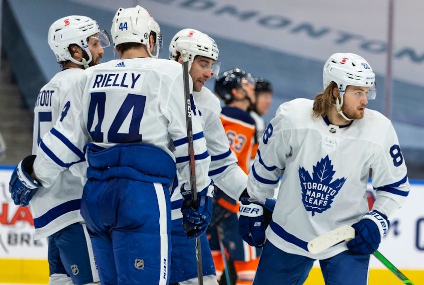 Toronto Maple Leafs’ William Nylander (88) celebrates a goal on Edmonton Oilers’ goaltender Mike Smith (41) with teammates at Rogers Place in Edmonton on Wednesday, March 3, 2021.