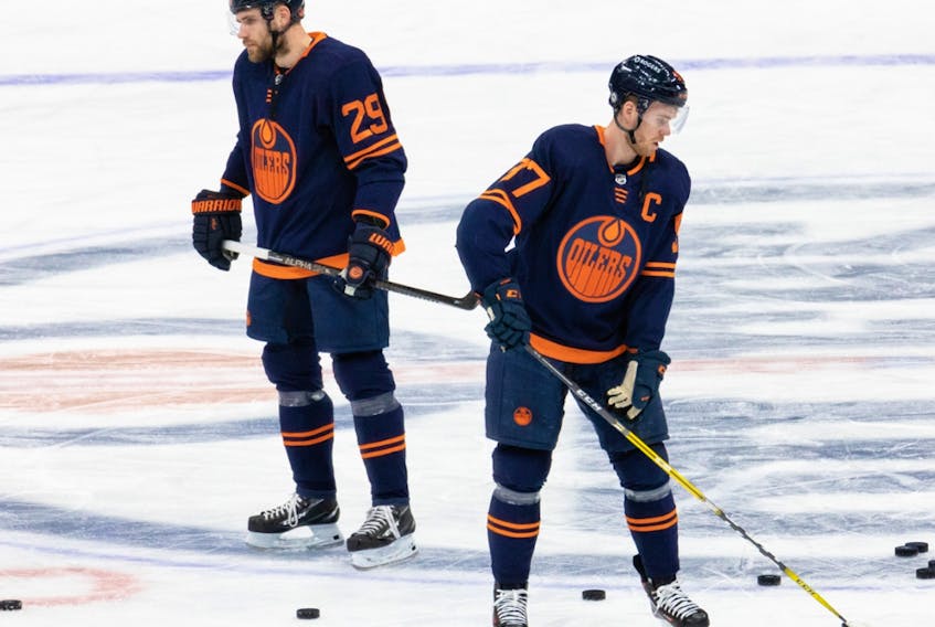 Edmonton Oilers Leon Draisaitl (29) and Connor McDavid (97) warm up before an NHL game against the Winnipeg Jets at Rogers Place in Edmonton on Saturday, March 20, 2021.